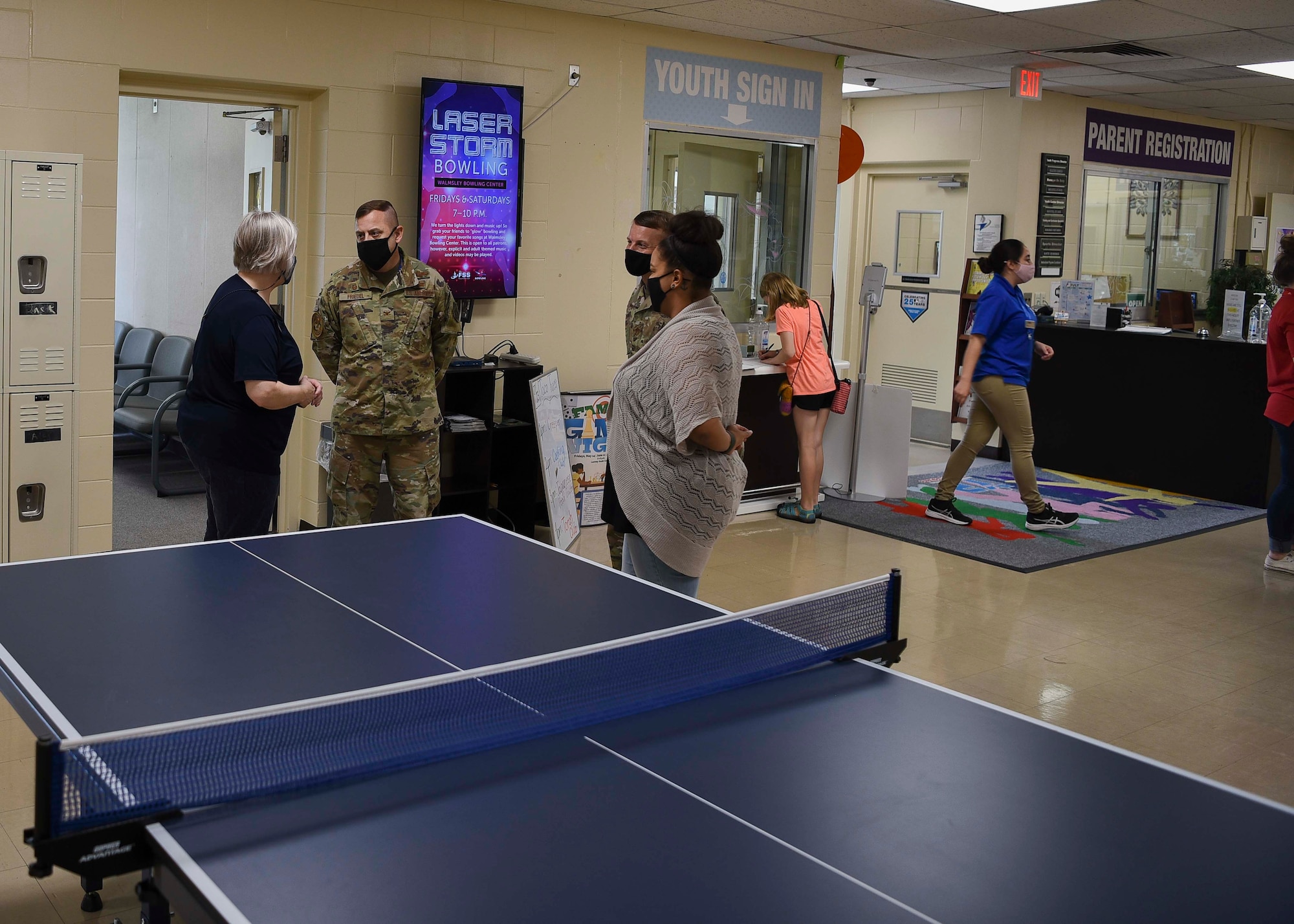 Military members talk to Lunney Youth Center members in the center.