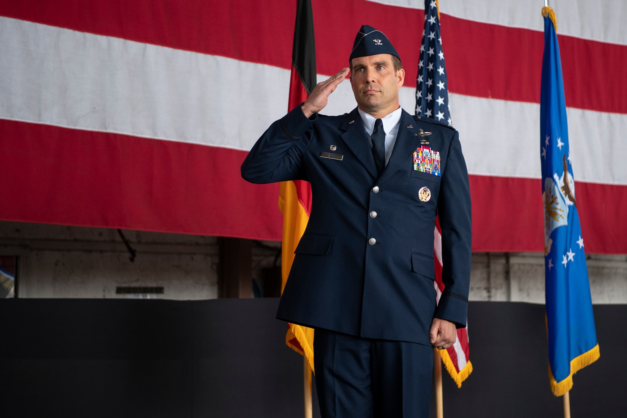 U.S. Air Force Col. Leslie Hauck, 52nd Fighter Wing incoming commander, renders his first salute during the 52nd FW Change of Command ceremony July 15, 2021, on Spangdahlem Air Base, Germany. Hauck will be taking command over the 52nd Fighter Wing, which has a total population of 5,000 Airmen and civilian personnel. (U.S. Air Force photo by Staff Sgt. Melody W. Howley)