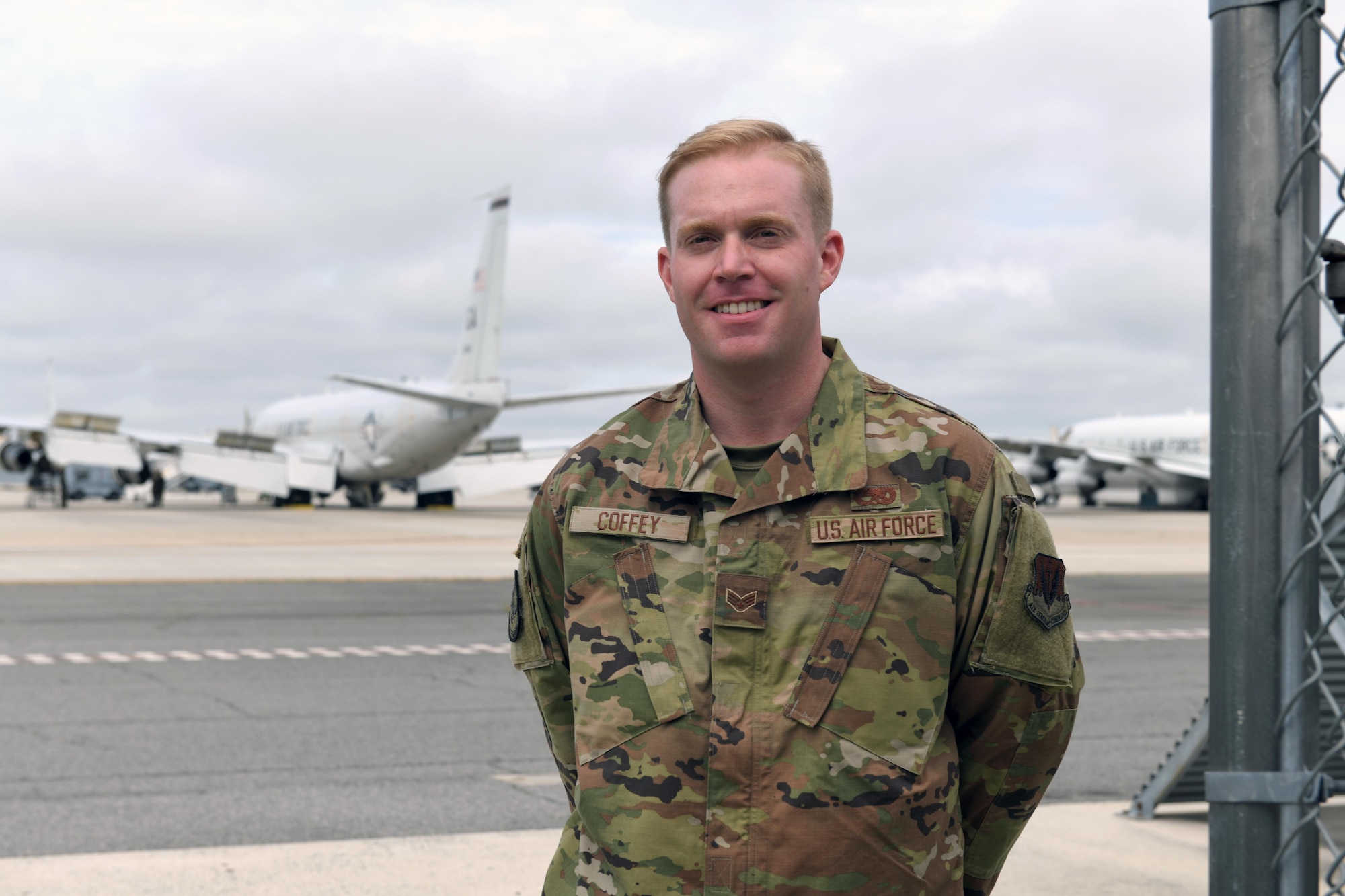Photo shows Airman standing with a JSTARS aircraft in the background.