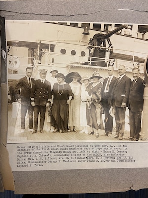 A photo of a Coast Guard personnel and civilians in 1923.