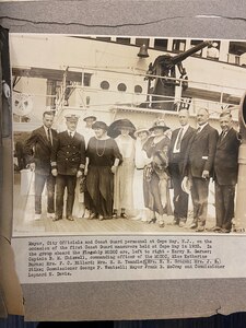 A photo of a Coast Guard personnel and civilians in 1923.