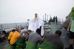 NORWEGIAN SEA (July 8, 2021) Sailors aboard the Arleigh Burke-class guided-missile destroyer USS Roosevelt (DDG 80) participate in an “Order of the Blue Nose” ceremony, July 8, 2021. Roosevelt, forward-deployed to Rota, Spain, is on its second patrol in the U.S. Sixth Fleet area of operations in support of regional allies and partners and U.S. national security interests in Europe and Africa. (U.S. Navy photo by Mass Communication Specialist 2n)