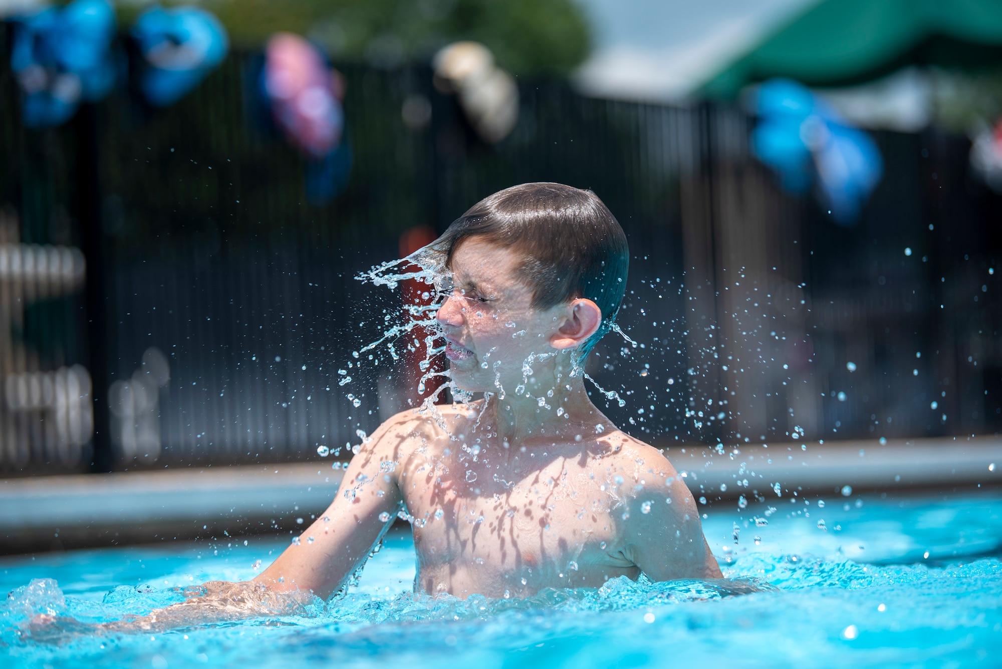 Cole Wexler, son of Master Sgt. Arik Wexler, 736th Aircraft Maintenance Squadron lead production superintendent, comes up for air at the Oasis Pool at Dover Air Force Base, Del., July 14, 2021. During summer break, the pool is open 11 am to 7 pm daily for military members, family and friends. The pool no longer has block sessions for attendees, but has a capacity limit of 200 people.  (U.S. Air Force photo by Tech. Sgt. Nicole Leidholm)