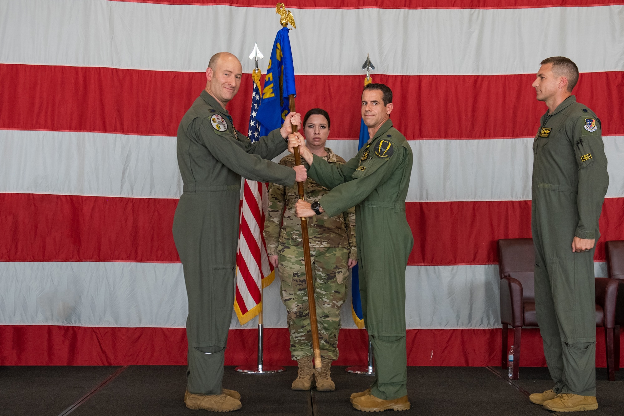 Col. Mathew Miller, 419th Operations Group commander, passes the squadron flag to Lt. Col. Shad Stromberg, the new 466th Fighter Squadron commander, during a ceremony July 11, 2021, at Hill Air Force Base, Utah.