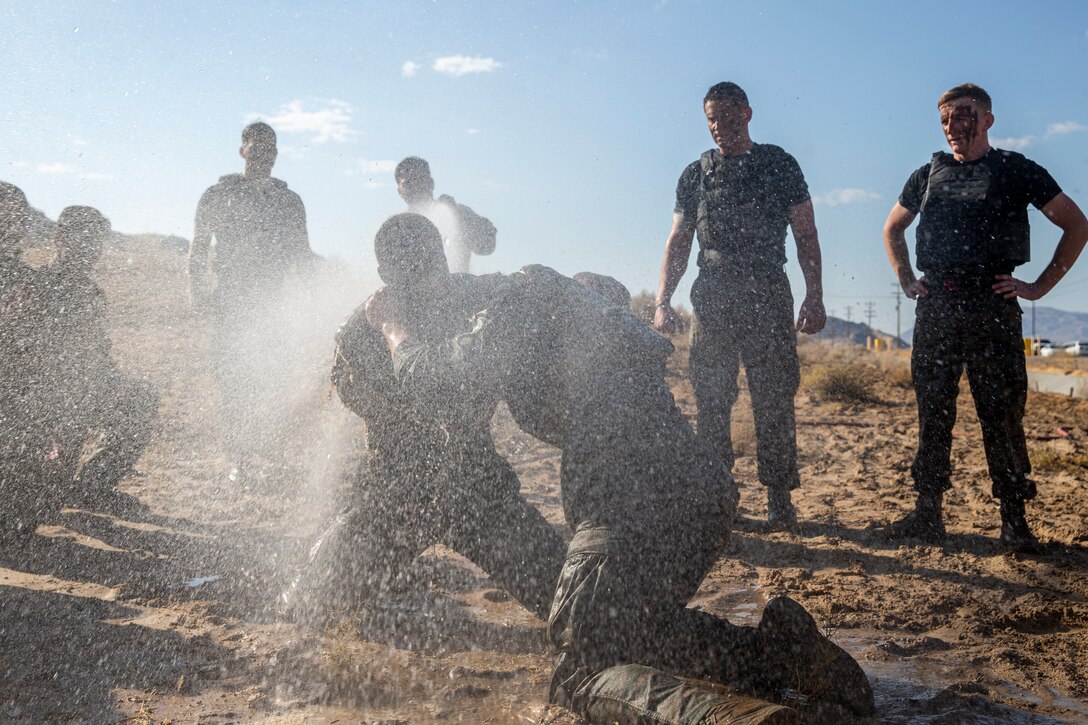 U.S. Marines with Marine Corps Martial Arts Instructors Course 2-21 ground fight during a culminating training event at Marine Corps Air Ground Combat Center, Twentynine Palms, California, June 24, 2021. MAIC is a 3-week-long training event that qualifies Marines to lead and instruct Marine Corps Martial Arts. (U.S. Marine Corps photo by Lance Cpl. Joshua Sechser)