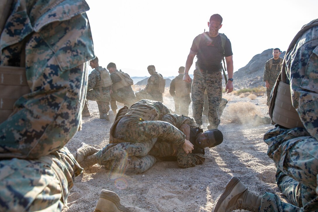 U.S. Marines with Marine Corps Martial Arts Instructors Course 2-21 ground fight during a culminating training event at Marine Corps Air Ground Combat Center, Twentynine Palms, California, June 24, 2021. MAIC is a 3-week-long training event that qualifies Marines to lead and instruct Marine Corps Martial Arts. (U.S. Marine Corps photo by Lance Cpl. Joshua Sechser)