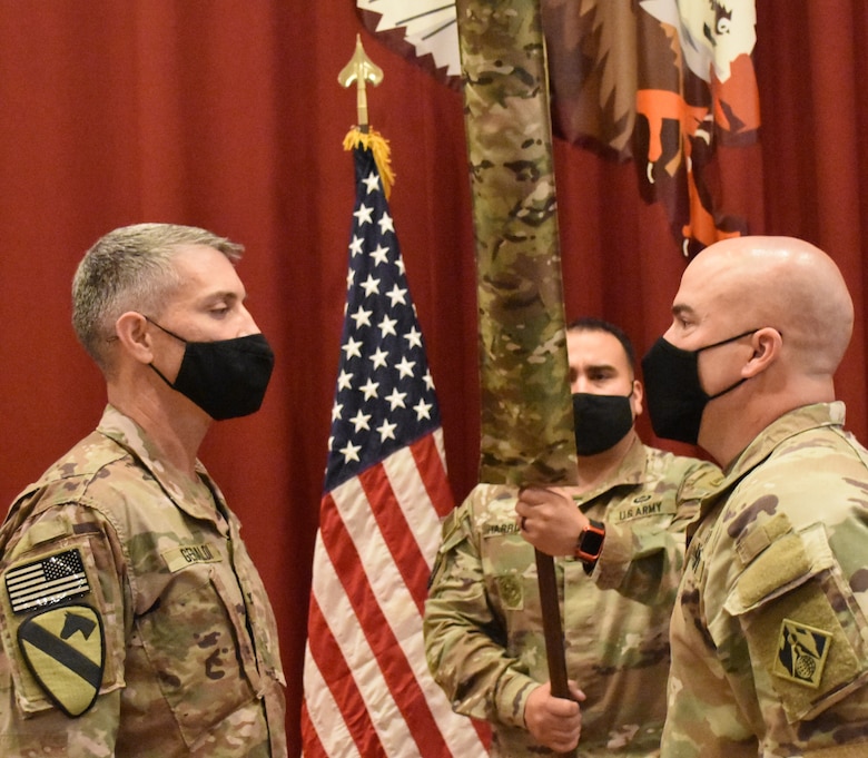 Colonel Mark Geraldi and Master Sergeant Ronald Brown prepare to receive the colors of the new USACE District during the uncasing ceremony held at Camp Arifjan, Kuwait on May 15, 2021. (Photo by Rick Benoit)