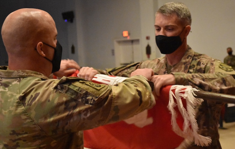 Master Sergeant Ronald Brown, Senior Enlisted Advisor and Colonel Mark Geraldi, Commander uncase the colors of the newest district under the U. S. Army Corps of Engineer’s umbrella, the Transatlantic Expeditionary District. (Photo by Rick Benoit)