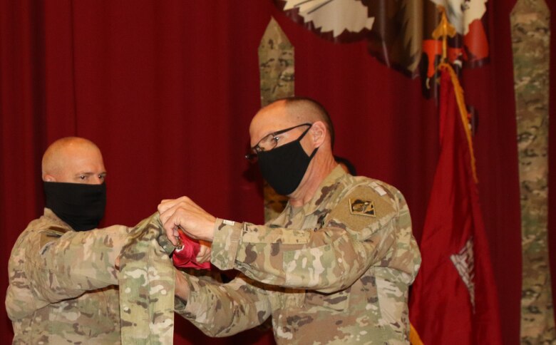 With Task Force Essayons consolidating within the Transatlantic Expeditionary District, the colors of the former command will remain cased, as Colonel John Haas, Jr. and SGM William Klaers complete this final act on May 15, 2021. (Photo by Rick Benoit)