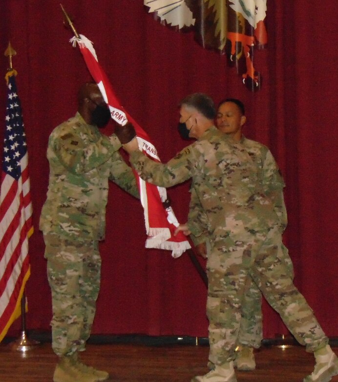 Colonel Kenneth N. Reed receives the command colors as he assumes command of the Transatlantic Expeditionary District at Camp Arifjan, Kuwait on June 28, 2021 from outgoing commander, Colonel Mark A. Geraldi. (Photo by Cecilia Polanco)