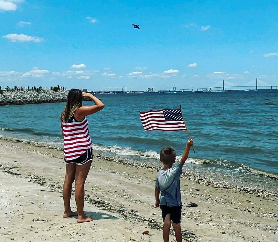 Airplane fan, Jace Adkins and his mother Leslie enjoy the annual "Salute from the Shore" celebration in Charleston, South Carolina as a C-17 Globmaster III, flown by the 701st Airlift Squadron,  and other aircraft fly over the South Carolin Coast July 4, 2021.  (Photo courtesy Adkins family)