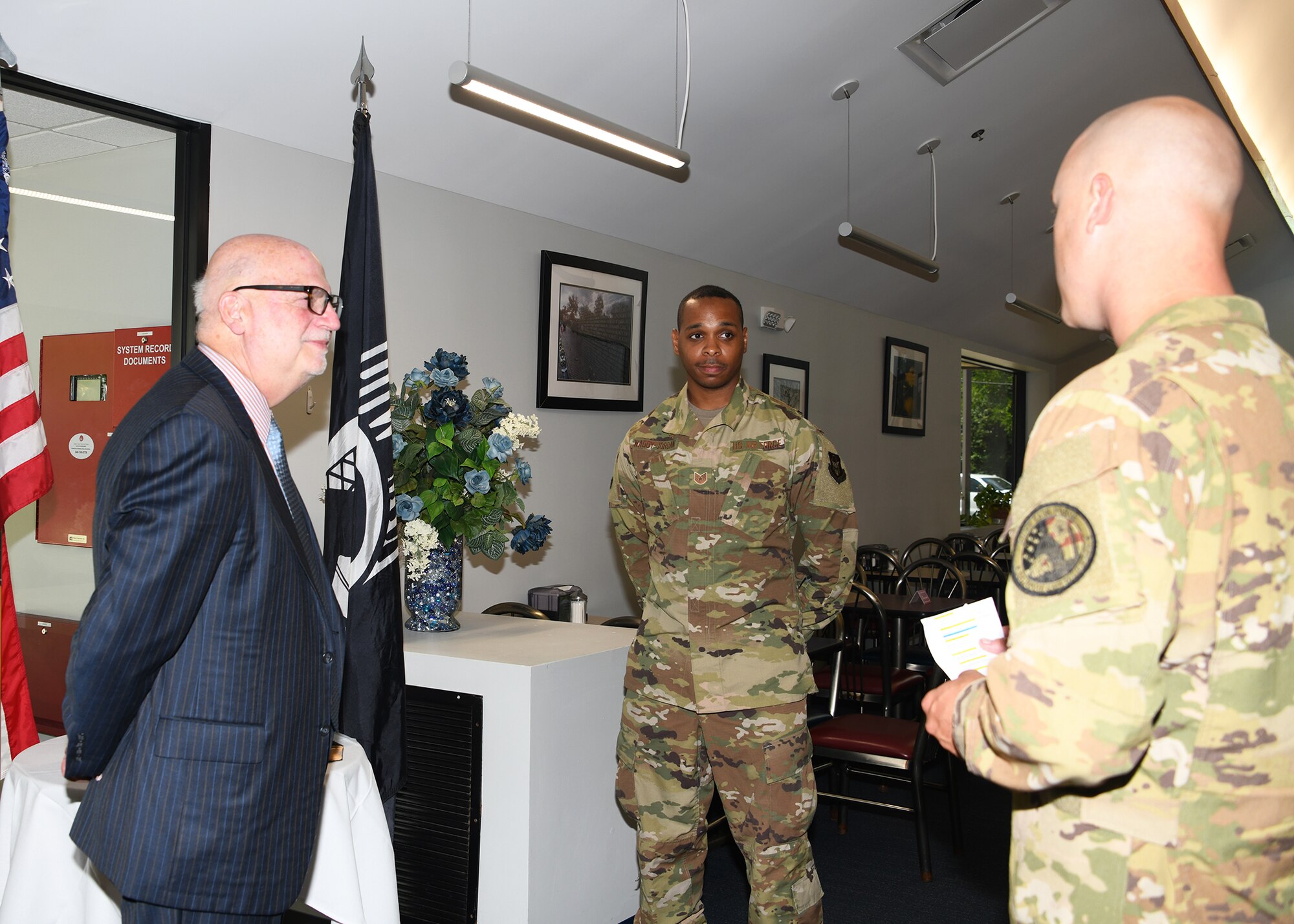 Acting Secretary of the Air Force John P. Roth stands alongside Tech Sgt. Kyle Waddy-Jordan, 459th Logistics Readiness Squadron material management technician, as Waddy-Jordan’s accomplishments are read during a coining ceremony July 14, 2021, at Joint Base Andrews, Md. During his visit to Joint Base Andrews, Mr. Roth recognized 12 outstanding Airmen from around the installation. (U.S. Air Force photo by Staff Sgt. Cierra Presentado/Released)