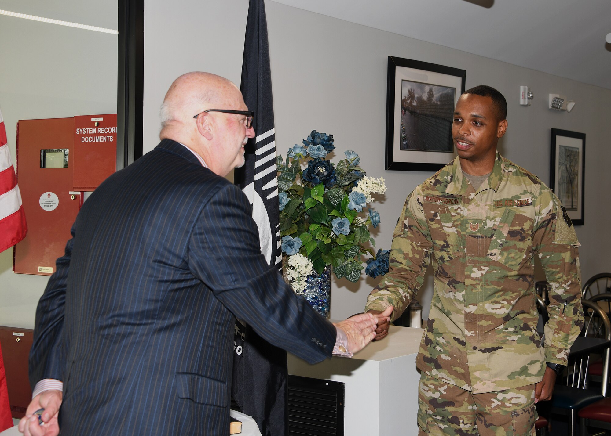 Acting Secretary of the Air Force John P. Roth coins Tech Sgt. Kyle Waddy-Jordan, 459th Logistics Readiness Squadron material management technician, for his outstanding accomplishments June 14, 2021, at Joint Base Andrews, Md. During his visit to Joint Base Andrews, Mr. Roth recognized 12 outstanding Airmen from around the installation. (U.S. Air Force photo by Staff Sgt. Cierra Presentado/Released)