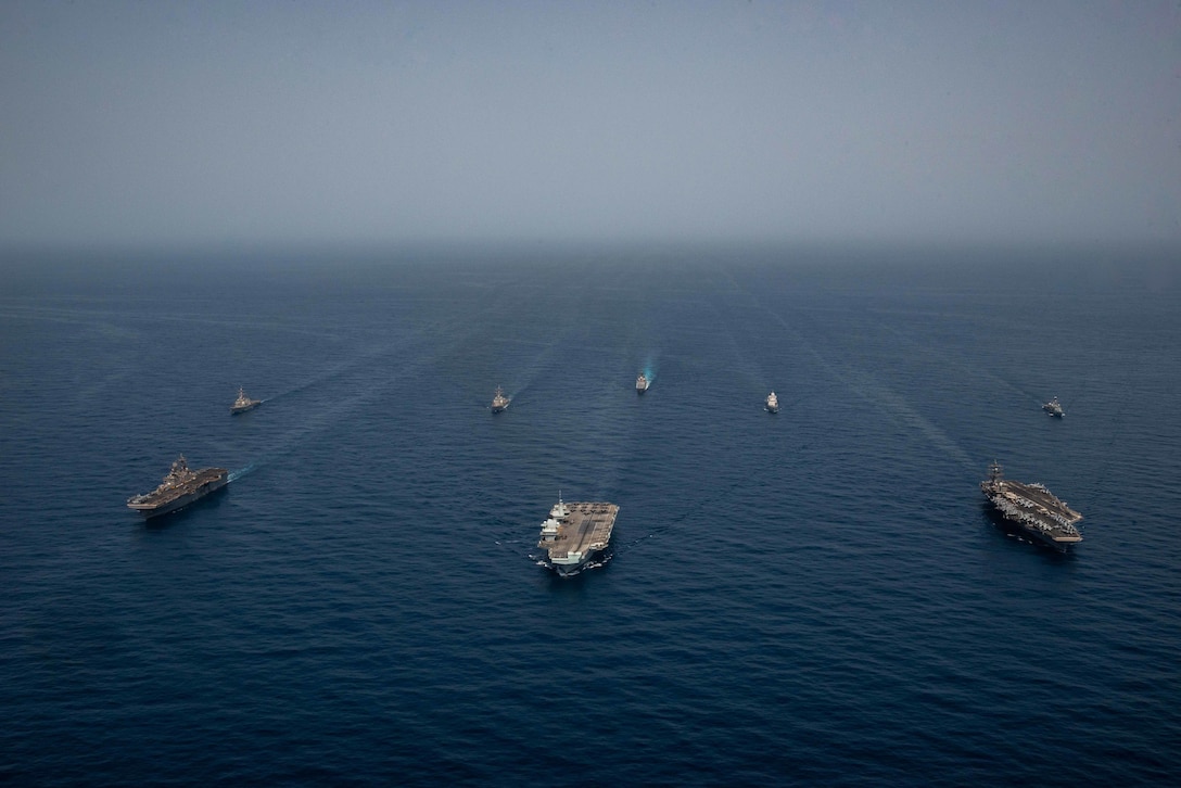 GULF OF ADEN (July 12, 2021) Ships of the UK Carrier Strike Group, USS Ronald Reagan Carrier Strike Group, and Iwo Jima Amphibious Ready Group operate in formation in the Gulf of Aden, July 12. UK, Dutch and U.S. naval forces conducted an integrated at-sea exercise designed to enhance maritime interoperability and demonstrate naval integration through a series of training scenarios. (U.S. Navy photo by Mass Communication Specialist Seaman Gray Gibson)