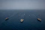 GULF OF ADEN (July 12, 2021) Ships of the UK Carrier Strike Group, USS Ronald Reagan Carrier Strike Group, and Iwo Jima Amphibious Ready Group operate in formation in the Gulf of Aden, July 12. UK, Dutch and U.S. naval forces conducted an integrated at-sea exercise designed to enhance maritime interoperability and demonstrate naval integration through a series of training scenarios. (U.S. Navy photo by Mass Communication Specialist Seaman Gray Gibson)