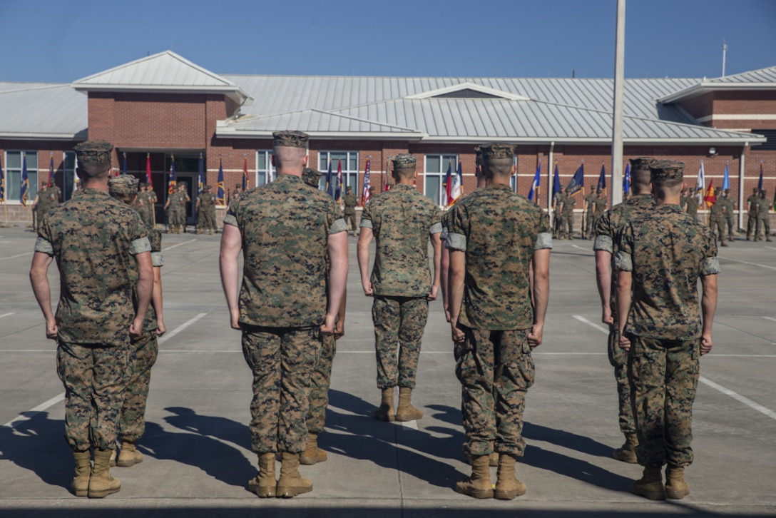 Off-going and on-coming Commanders, LtCols Zachary A. Coates and Amanda N. Donnelly survey the Command.