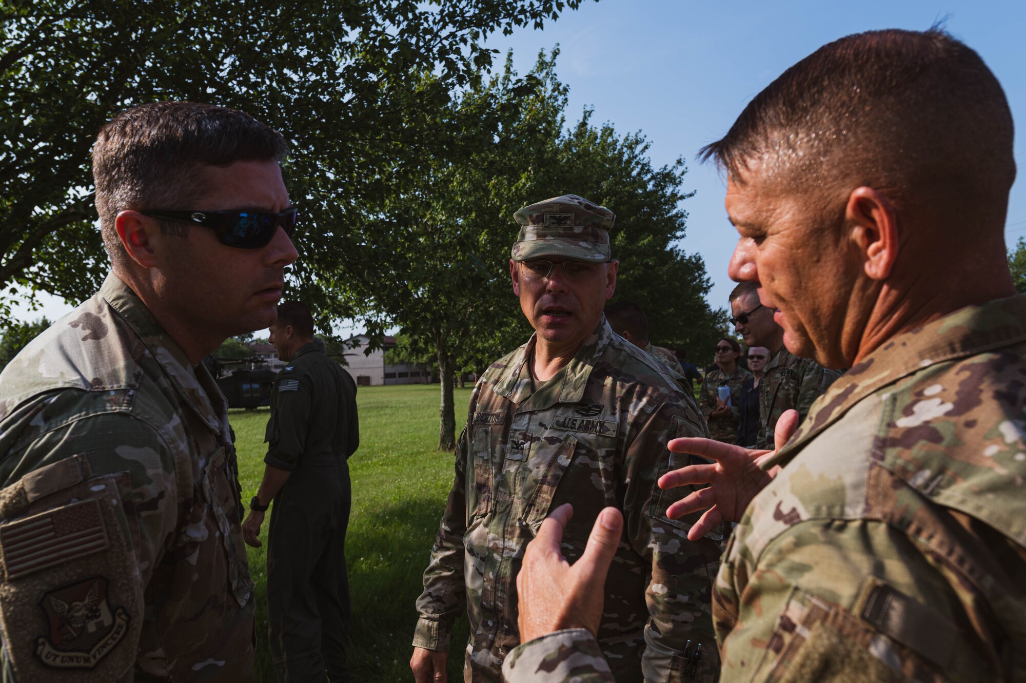 U.S. Air Force Col. Wes Adams, Joint Base McGuire-Dix-Lakehurst commander and 87th Air Base Wing commander, speaks to U.S. Army Command Sgt. Maj. Donald J. Gallagher II, U.S. NCO Academy command sergeant, and Col. Jon A. Brierton, Army Support Activity, Dix commander, on Joint Base McGuire-Dix-Lakehurst
