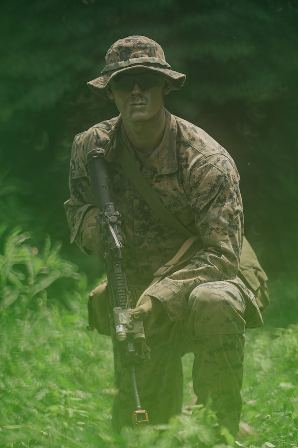 U.S. Marine Corps LCpl. Joshua Baily, a machine gunner with Lima Co., Third Battalion, 23rd Marine Regiment, poses for a photo while training for a squad competition at Fort Knox, Kentucky, on June 26, 2021. The goal of this training is to enable a rifle squad to complete any mission by perfecting skills like land navigation, patrolling, offensive and defensive postures, and mastery of weapons and tactics. (U.S. Marine Corps photo by Cpl. James Stanfield)