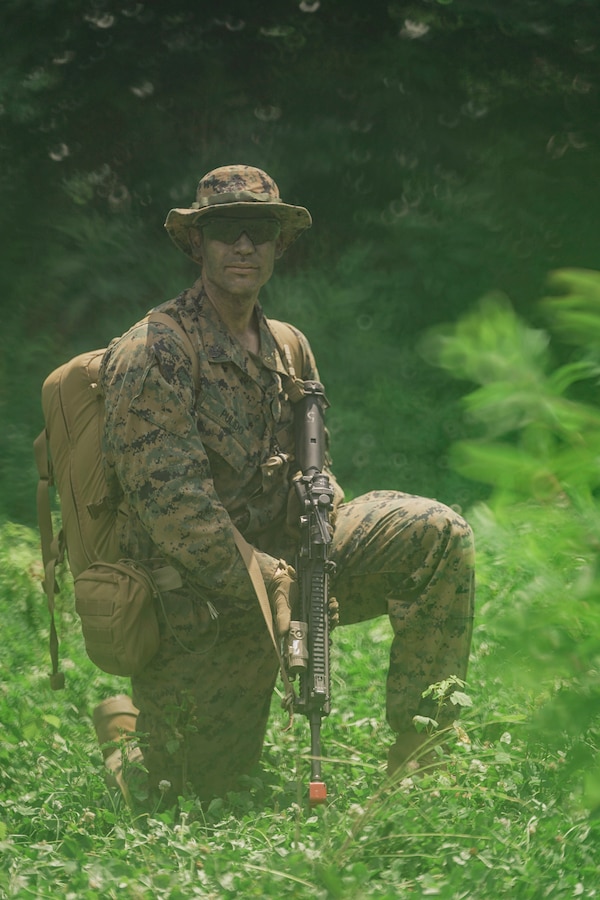 U.S. Navy Hospitalman First Class Roberto Pulido, a Corpsman with Lima Company, Third Battalion, 23rd Marine Regiment, poses for a photo while training for a squad competition at Fort Knox, Kentucky, on June 26, 2021. The goal of this training is to enable a rifle squad to complete any mission by perfecting skills like land navigation, patrolling, offensive and defensive postures, and mastery of weapons and tactics. (U.S. Marine Corps photo by Cpl. James Stanfield)