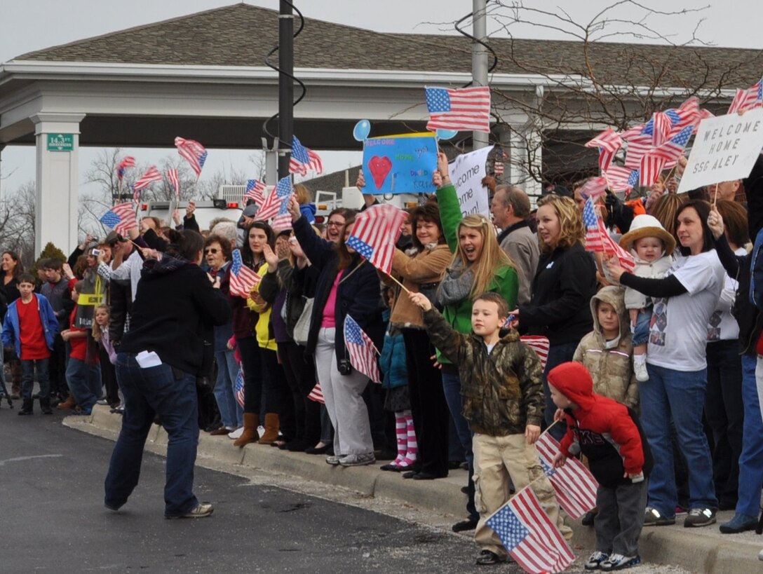 Family and friends of the 2123rd Transportation Company cheer for their Soldier as they arrive for the welcome home ceremony in Richmond, Ky., Feb. 4 after their tour in Afghanistan.