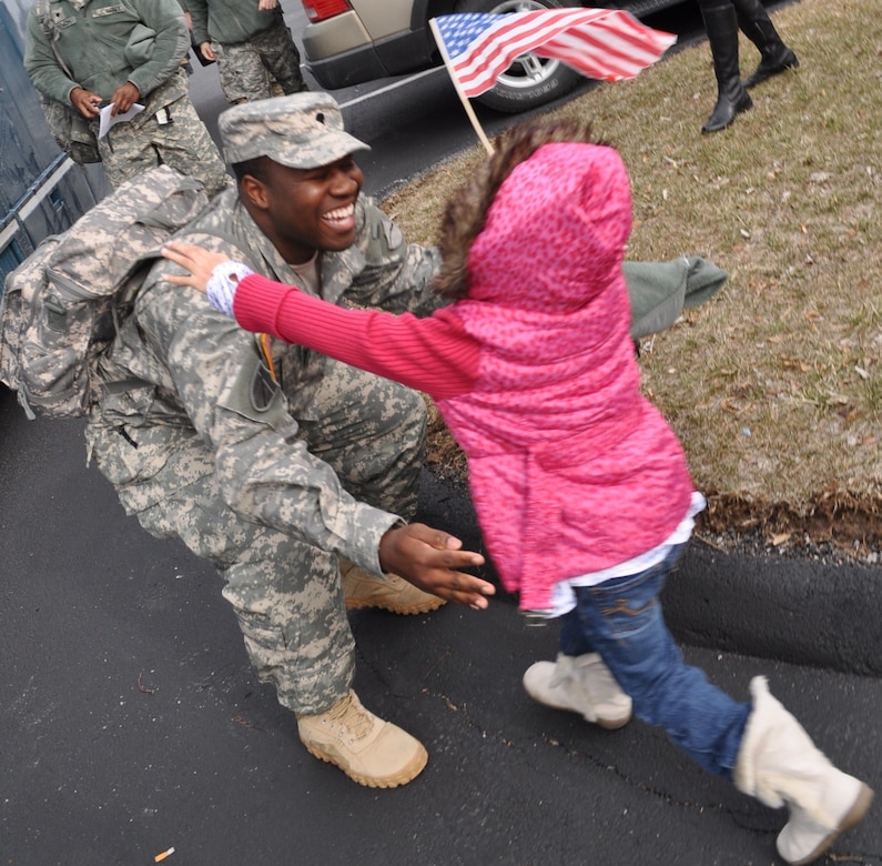 Spc. DaRun Poe, 2123rd Transportation Company truck driver, gives his little daughter, Arianna, a big hug after coming back from his deployment in Afghanistan at the welcome home ceremony in Richmond, Ky., Feb. 4