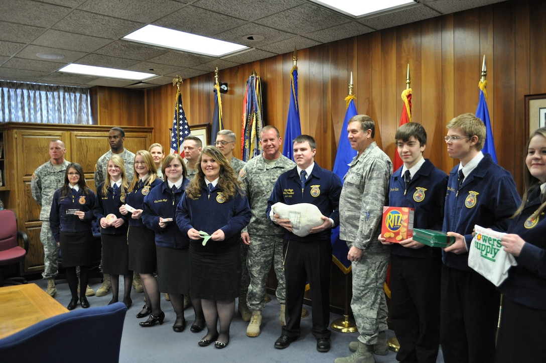 Maj. Gen. Edward W. Tonini, adjutant general of Kentucky, joins with members of KYADT 3 in receiving donations from Future Farmers of America in Frankfort, Ky., Jan. 27.