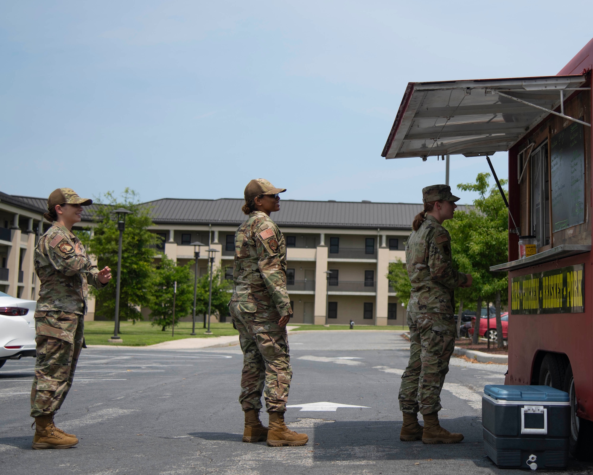 Airmen wait in line to purchase meals at a food truck in front of the Patterson Dining Facility at Dover Air Force Base, Delaware, July 15, 2021. The Patterson Dining Facility closed for renovations on its electrical systems and walk-in refrigerator. The 436th Force Support Squadron coordinated bringing various food trucks onto Dover AFB to provide options for Airmen during the closure. (U.S. Air Force photo by Tech. Sgt. J.D. Strong II)