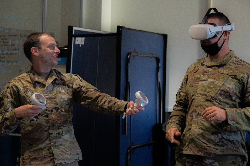 U.S. Air Force Tech. Sgt. Devin Bable, 305th Aircraft Maintenance Squadron integrated communications navigation system craftsman, displays a virtual reality training simulation to Airmen at the Infinity Spark Innovation Lab