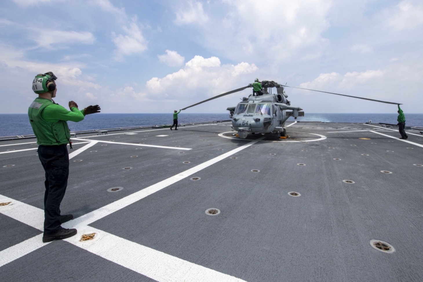 Sailors fold the rotors of an MH-60S Sea Hawk helicopter attached to Helicopter Sea Combat Squadron (HSC) 21, assigned to Independence-variant littoral combat ship USS Charleston (LCS 18), July 11.