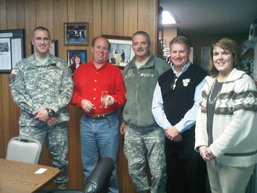 Capt. Bryan Combs, State Family Program director, Chief Warrant Officer 5 William Wason deputy director of Family Programs and Cindy Culver, State Youth coordinator, give the Kentucky Minuteman glass award to Tom Underwood, Kentucky Association of Executive in Frankfort, Ky., Jan. 20