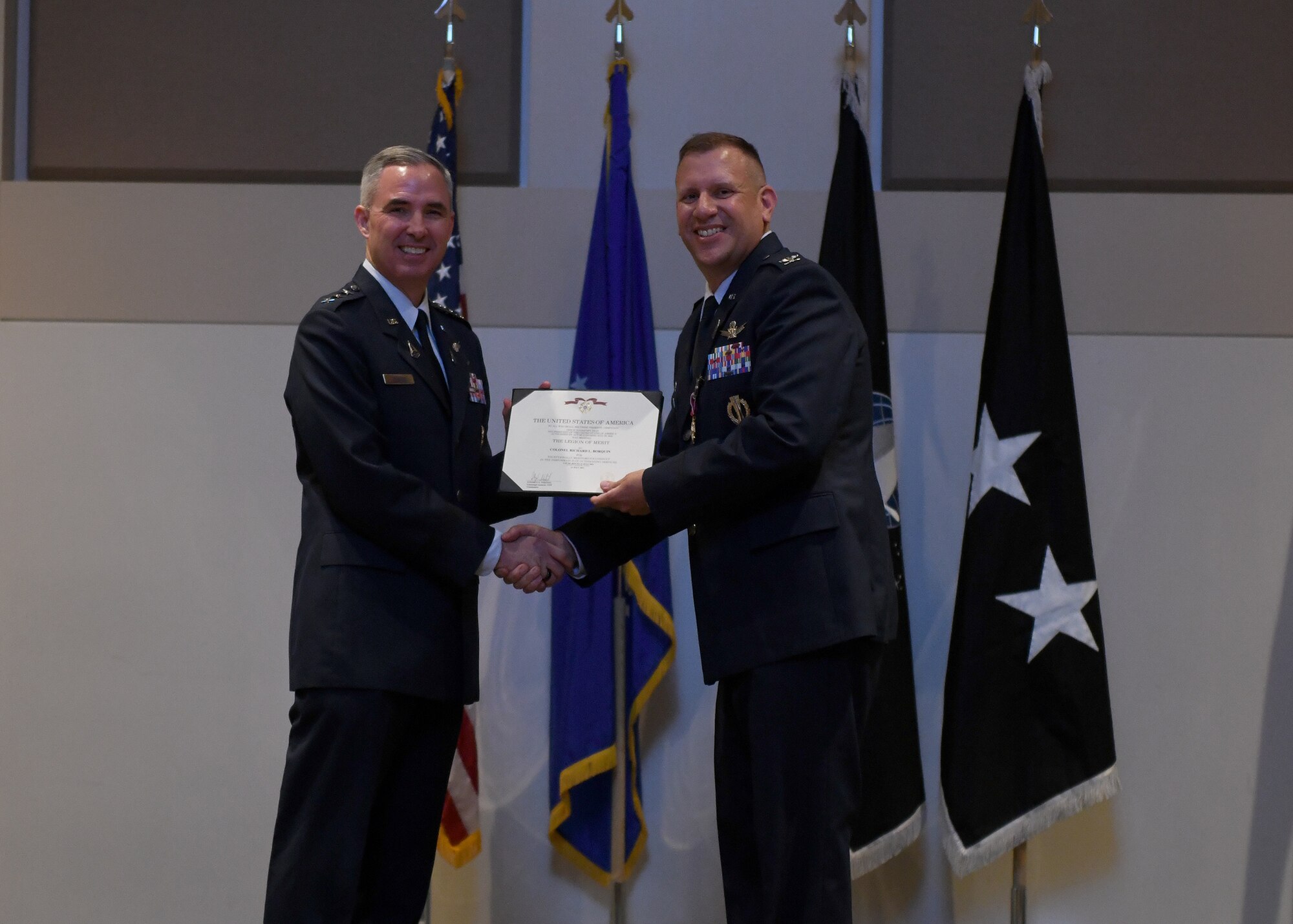 Col. Richard Bourquin, outgoing Space Delta 4 commander, poses with Lt. Gen. Stephen Whiting, Space Operations Command commander, after receiving the Legion of Merit medal during a change of command ceremony at Buckley Space Force Base, Colo., July 15, 2021. Prior to receiving the medal, Whiting reflected on Bourquin’s tenure as the first DEL 4 commander. (U.S. Space Force photo by Airman 1st Class Haley N. Blevins)