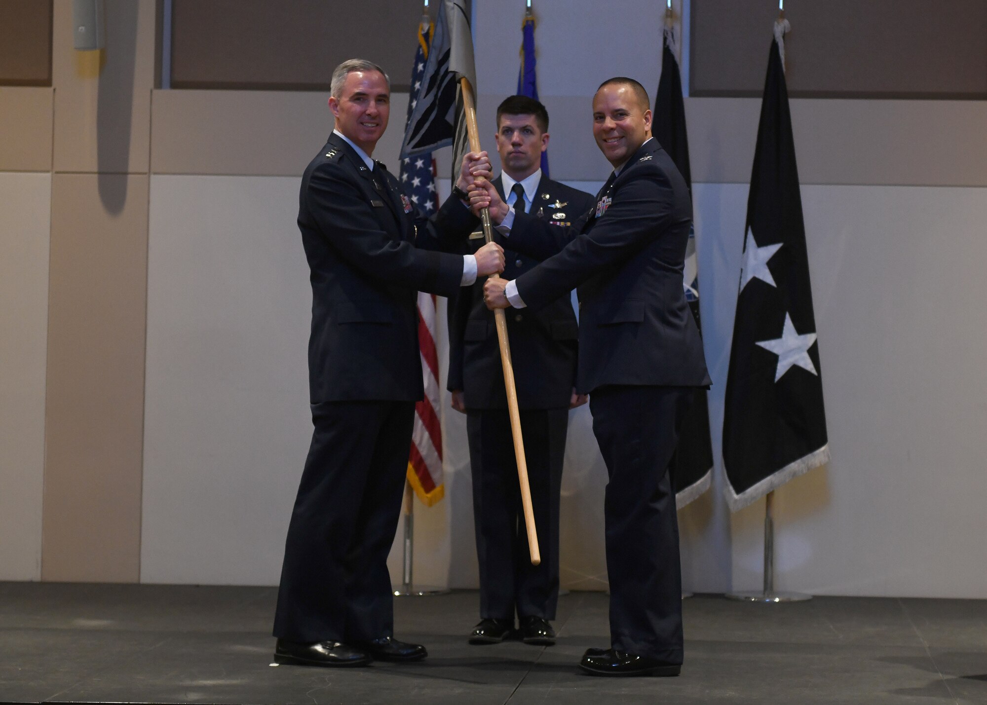 Col. Miguel Cruz, incoming Space Delta 4 commander, receives the guidon from Lt. Gen. Stephen Whiting, Space Operations Command commander, during a change of command ceremony at Buckley Space Force Base, Colo., July 15, 2021. The passing of the guidon is a military tradition that symbolizes a transfer of command and commemorates past leadership and success of the outgoing commander. (U.S. Space Force photo by Airman 1st Class Haley N. Blevins)