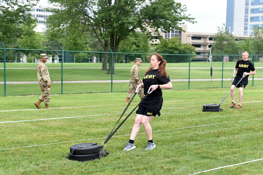 Staff Sgt. Alyssa N. Fowler, center, Human Resources Non-commissioned Officer, 84th Training Division, pulls a 90-pound sled during the Sprint-Drag-Carry portion of the Army Combat Fitness Test.