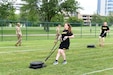 Staff Sgt. Alyssa N. Fowler, center, Human Resources Non-commissioned Officer, 84th Training Division, pulls a 90-pound sled during the Sprint-Drag-Carry portion of the Army Combat Fitness Test.