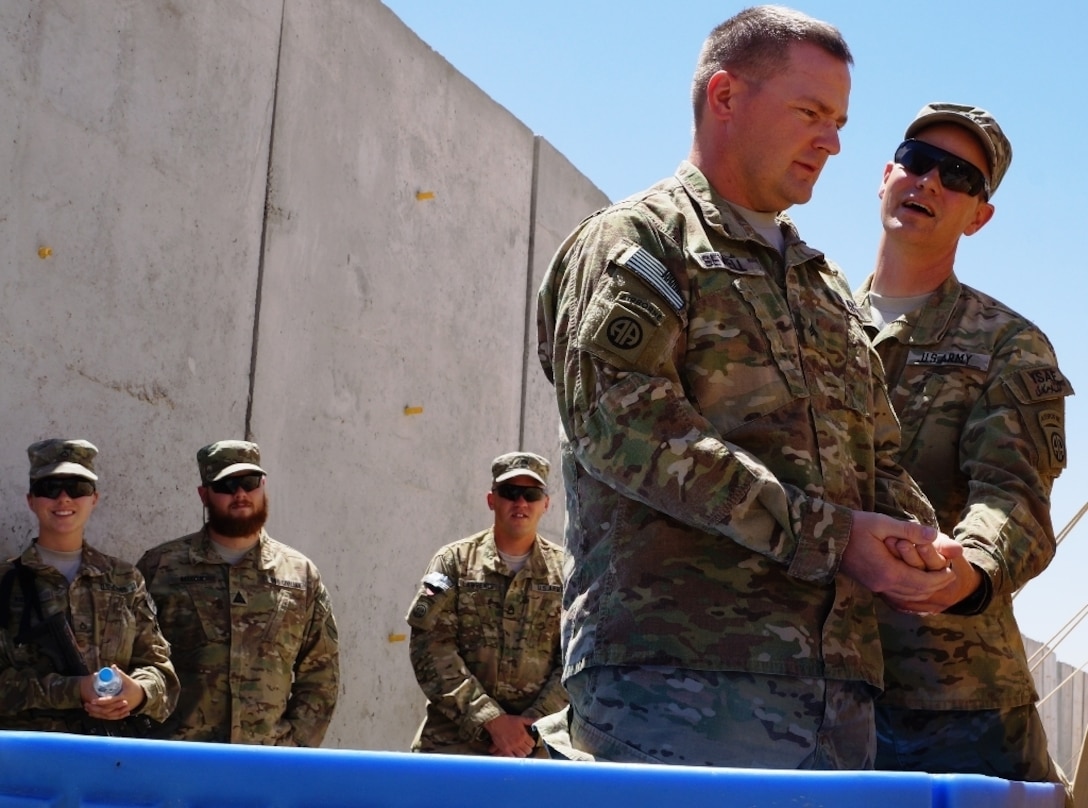 Sewell, a soldier from the Kentucky National Guard's Agribusiness Development Team 4 celebrated his re-dedication of faith through baptism following the day's worship service.