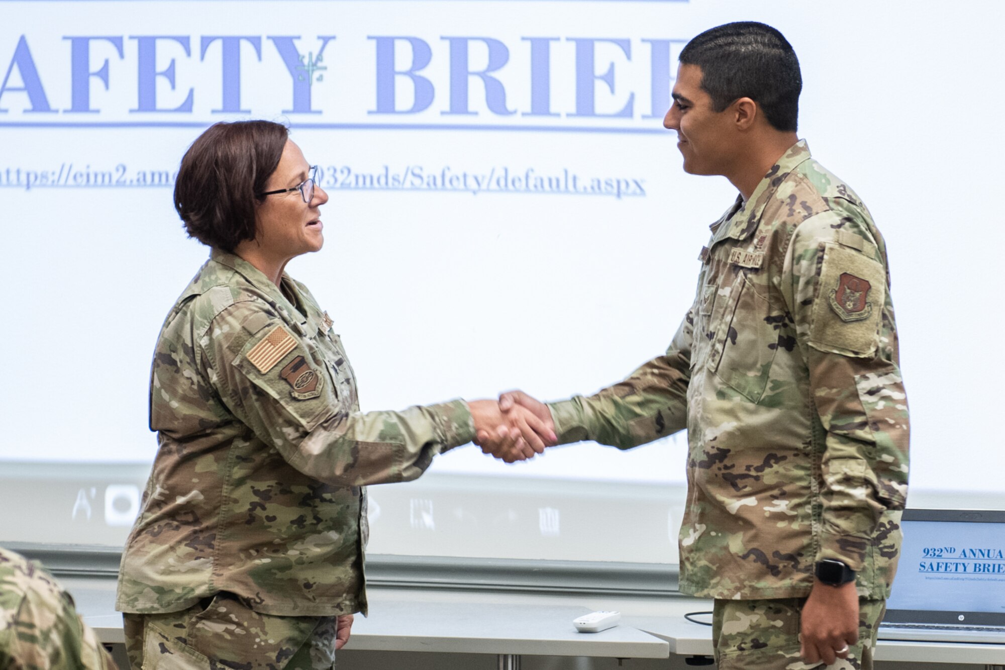 Lt. Col. Julie Novy, 932nd Airlift Wing, Inspector General Office, presents Senior Airman Warren McKeithen, 932nd AW, Medical Group, with an Inspector General coin at Scott Air Force Base, Illinois, July 10, 2021. During an active shooter drill McKeithen efficiently conducted a recall of the unit and realized there was a member who was non responsive. They simulated a death of a member and he was able to relay that one of his members was on base and was not found to the wing. McKeithen reacted to the situation properly unlike many units before him, earning him the IG coin! (U.S. Air Force Photo by Staff Sgt. Brooke Spenner)