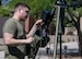 A photo of an airmen next to a weather station