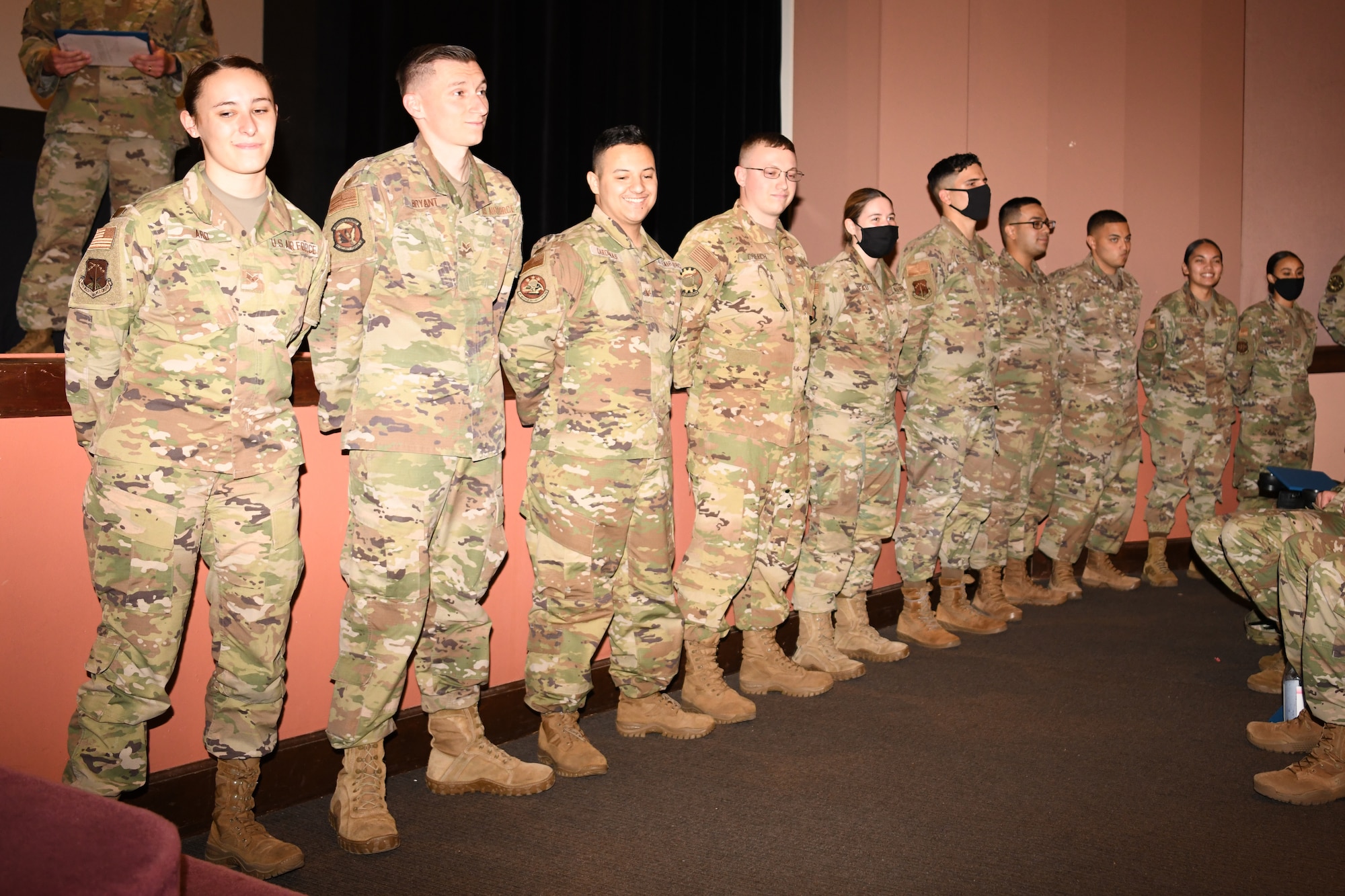 Members of the Honey Badger flight of ALS Class 21-F stand for recognition during their class graduation July 15, 2021, in the base theater on F. E. Warren Air Force Base, Wyo. ALS is a six-week course designed to prepare Airmen to assume supervisory duties as well as instruction in the practice of leadership and followership. Enlisted Airmen must graduate before supervising other Airmen. (U. S. Air Force photo by Airman 1st Class Charles Munoz)