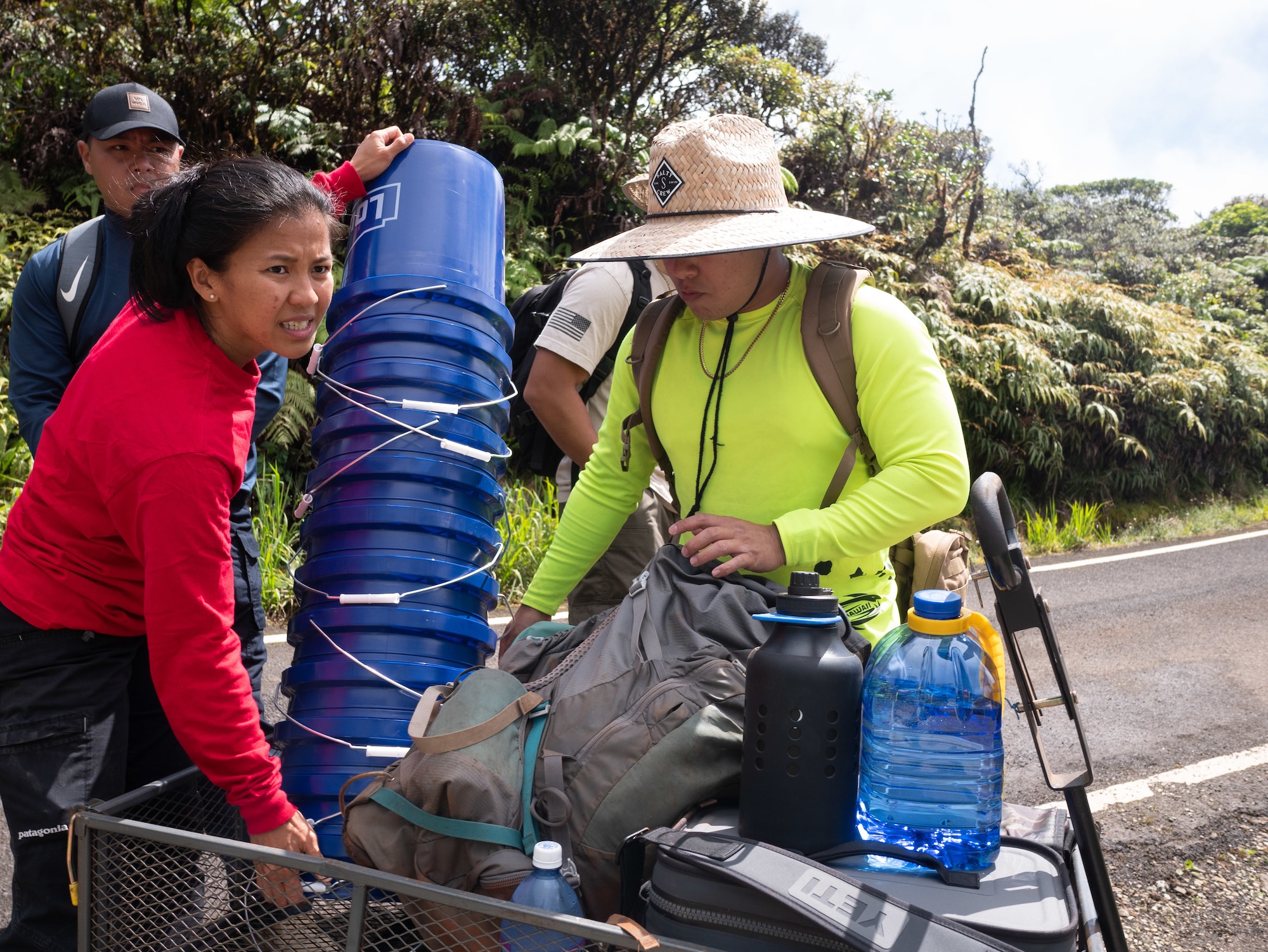 Airman 1st Class Genesaret Balladares,154th Security Forces Squadron member, grabs supplies during a volunteer event June 8, 2021, on Mount Kaala, Hawaii.