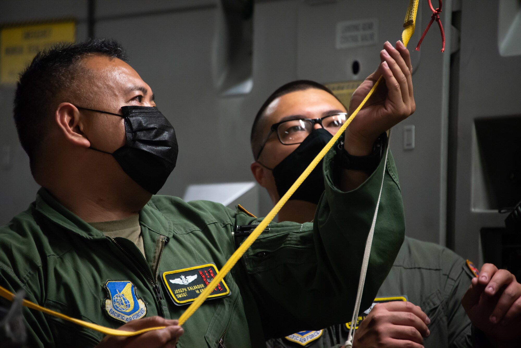 Senior Master Sgt. Joseph Salvador, and Staff Sgt. Justin Lun, 204th Airlift Squadron loadmasters, secure rescue equipment onto a C-17 Globemaster III May 18, 2021, at Moffett Federal Airfield, Calif. Hawaii