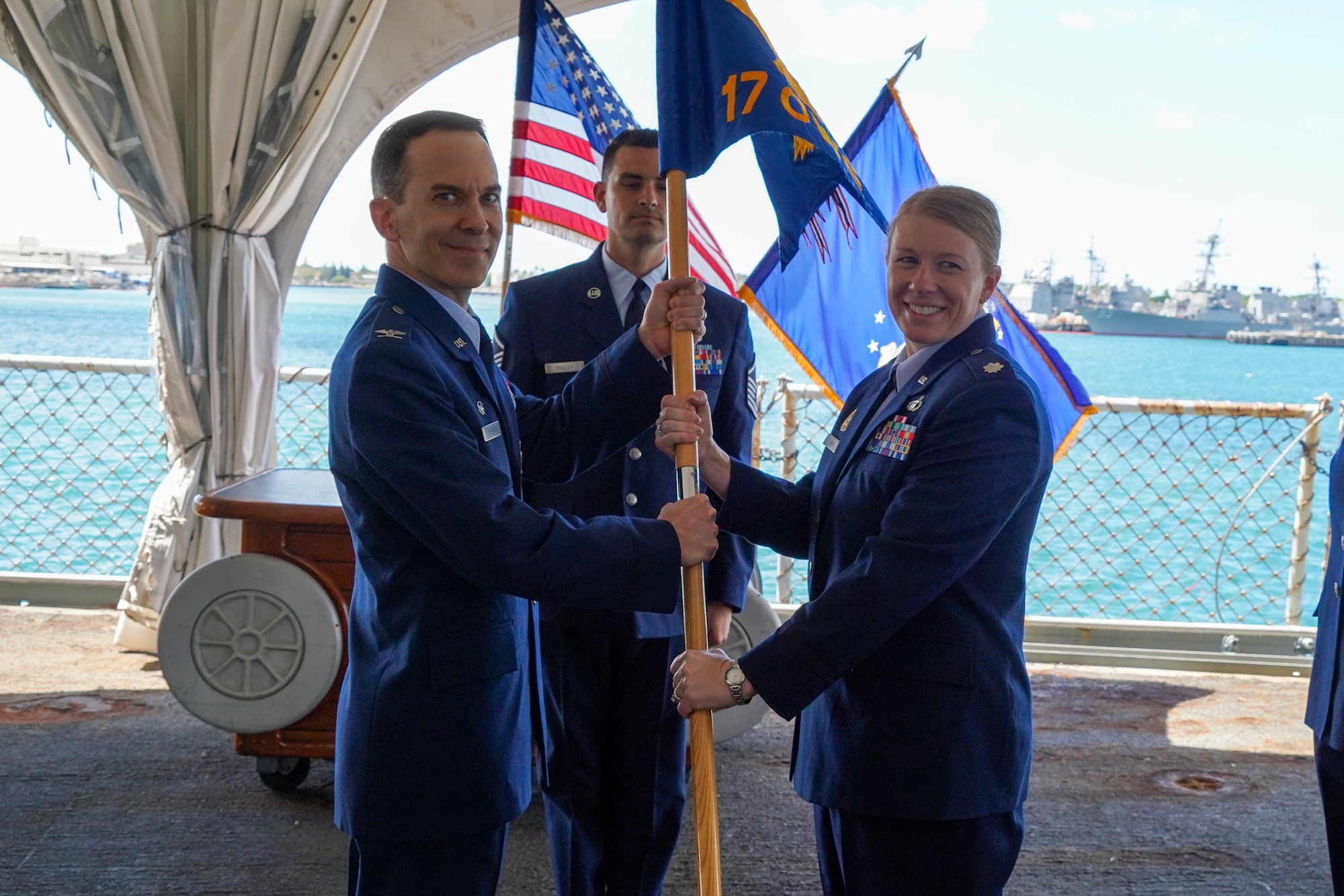 Lt. Col. Claire Jarry, assumes command of the 17th Operational Weather Squadron by accepting the guidon from Col. Bradley Stebbins, 1st Weather Group commander, during the 17th OWS change of command ceremony at Joint Base Pearl Harbor-Hickam, Hawaii, July 15, 2021. The 17th OWS provides weather support covering 113 million square miles of the Pacific Theater of operations. (U.S. Air Force photo by Airman 1st Class Makensie Cooper)