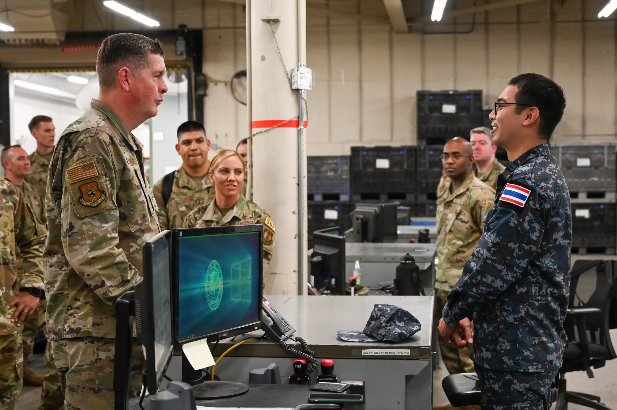 Lt. Gen. Kirkland speaks with 1st Lt. Terranuson while other Airmen look on in the background.