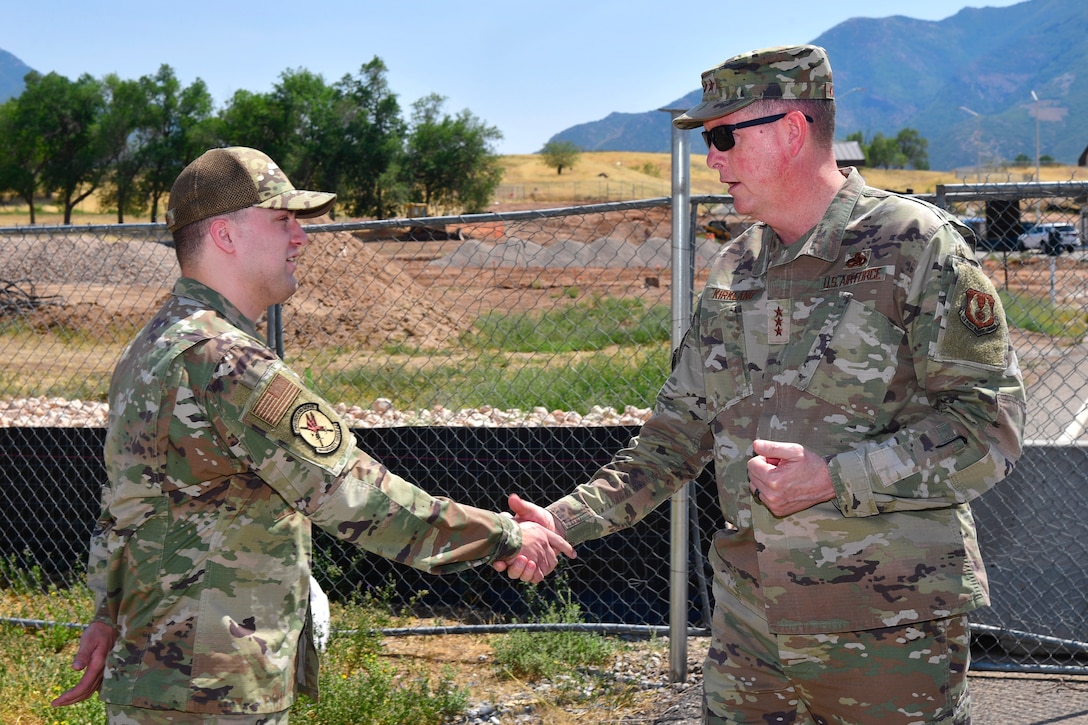 Senior Airman Stirling shakes hands with Lt. Gen. Kirkland.