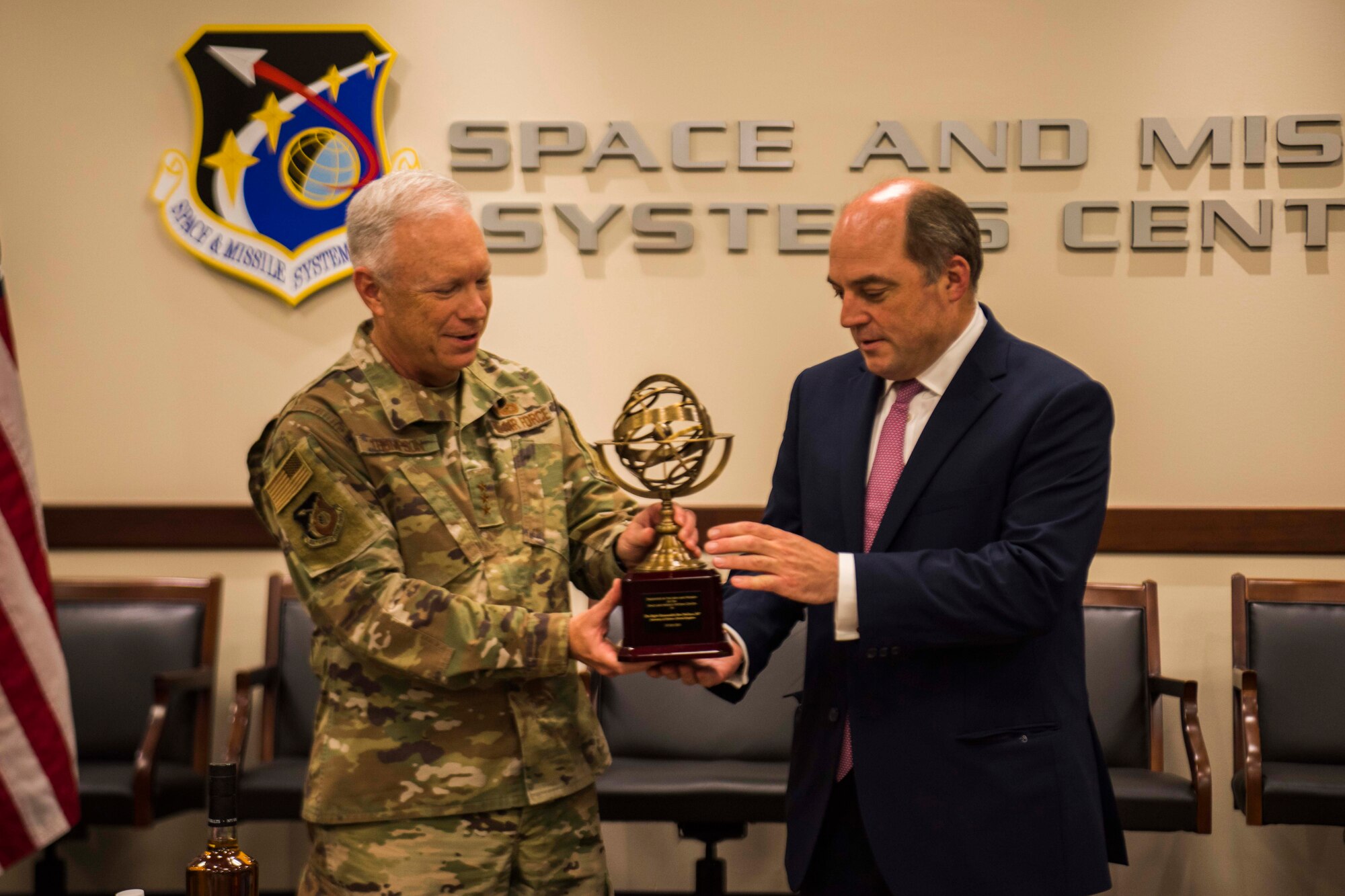 Lt. Gen. John F. Thompson, Space and Missile Systems Center commander and program executive officer for Space, left, gifts United Kingdom’s Secretary of State for Defence, the Right Honourable Ben Wallace MP, an Armillary Sphere modeled after the one featured in the SMC courtyard at Los Angeles Air Force Base, California, July 15, 2021. Armillary spheres, models of the sky, consist of a spherical framework of rings representing celestial longitude and latitude. (U.S. Space Force photo by Staff Sgt. Luke Kitterman)