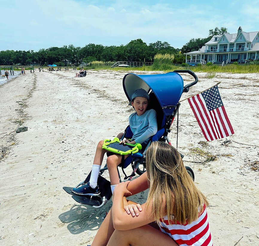 Airplane fan, Braiden Adkins and his mother Leslie enjoy the annual "Salute from the Shore" celebration in Charleston, South Carolina as a C-17 Globmaster III, flown by the 701st Airlift Squadron,  and other aircraft fly over the South Carolin Coast July 4, 2021