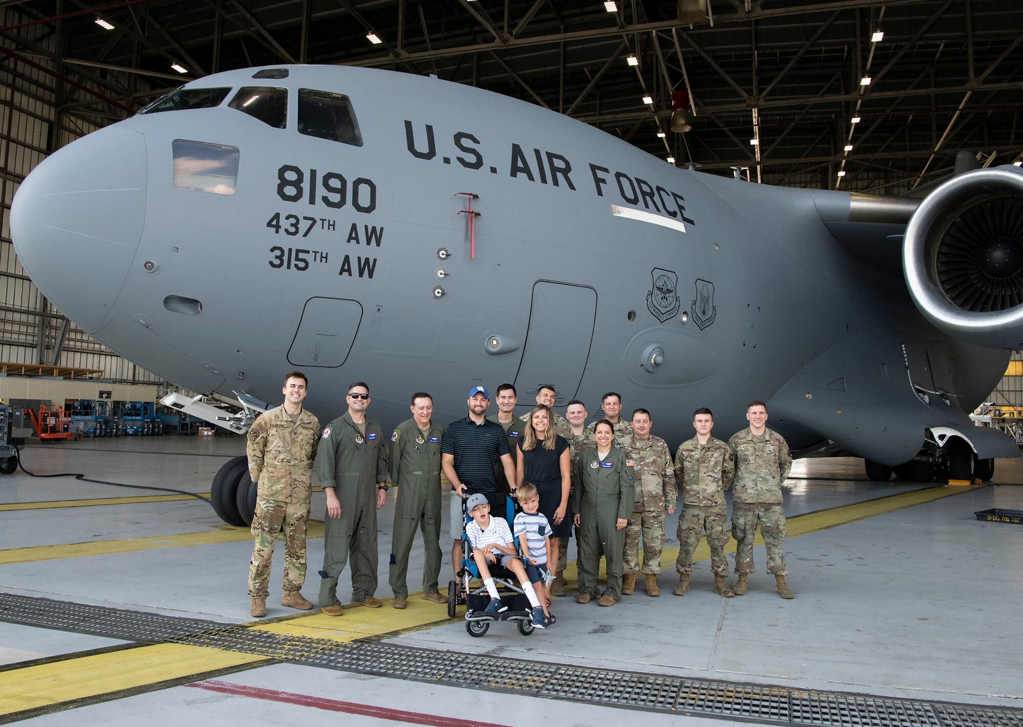 The Adkins family - Matt, Leslie, Braiden and Jace (center) pose for a group photo with aircrew and maintainers at Joint Base Charleston, South Carolina.