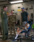 (From left) Master Sgt. James Ebert, 701st Airlift Squadron loadmaster, and Tech Sgt. Wade Griffith, 437th Maintenance Squadron, speak with Braiden and Matt Adkins while touring a C-17 Globemaster III at Joint Base Charleston, South Carolina July 14, 2021.