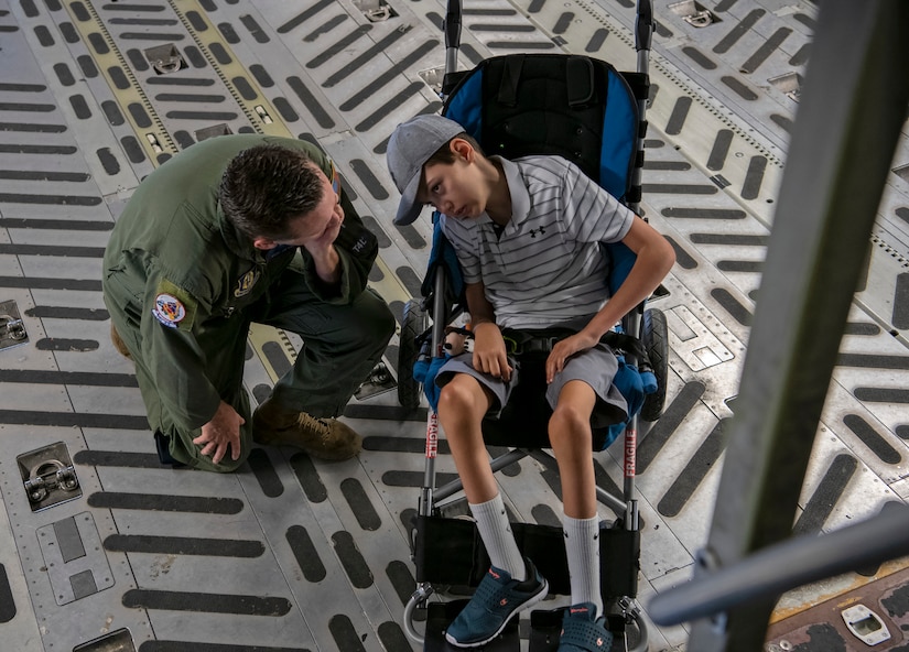 Mast Sgt. James Ebert, 701st Airlift Squadron loadmaster, tells Braiden Adkins about a Charleston C-17 Globemaster III that Adkins saw during the "Salute From the Shore" flyover on July Forth.