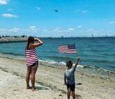 Airplane fan, Jace Adkins and his mother Leslie enjoy the annual "Salute from the Shore" celebration in Charleston, South Carolina as a C-17 Globmaster III, flown by the 701st Airlift Squadron,  and other aircraft fly over the South Carolin Coast July 4, 2021.  (Photo courtesy Adkins family)