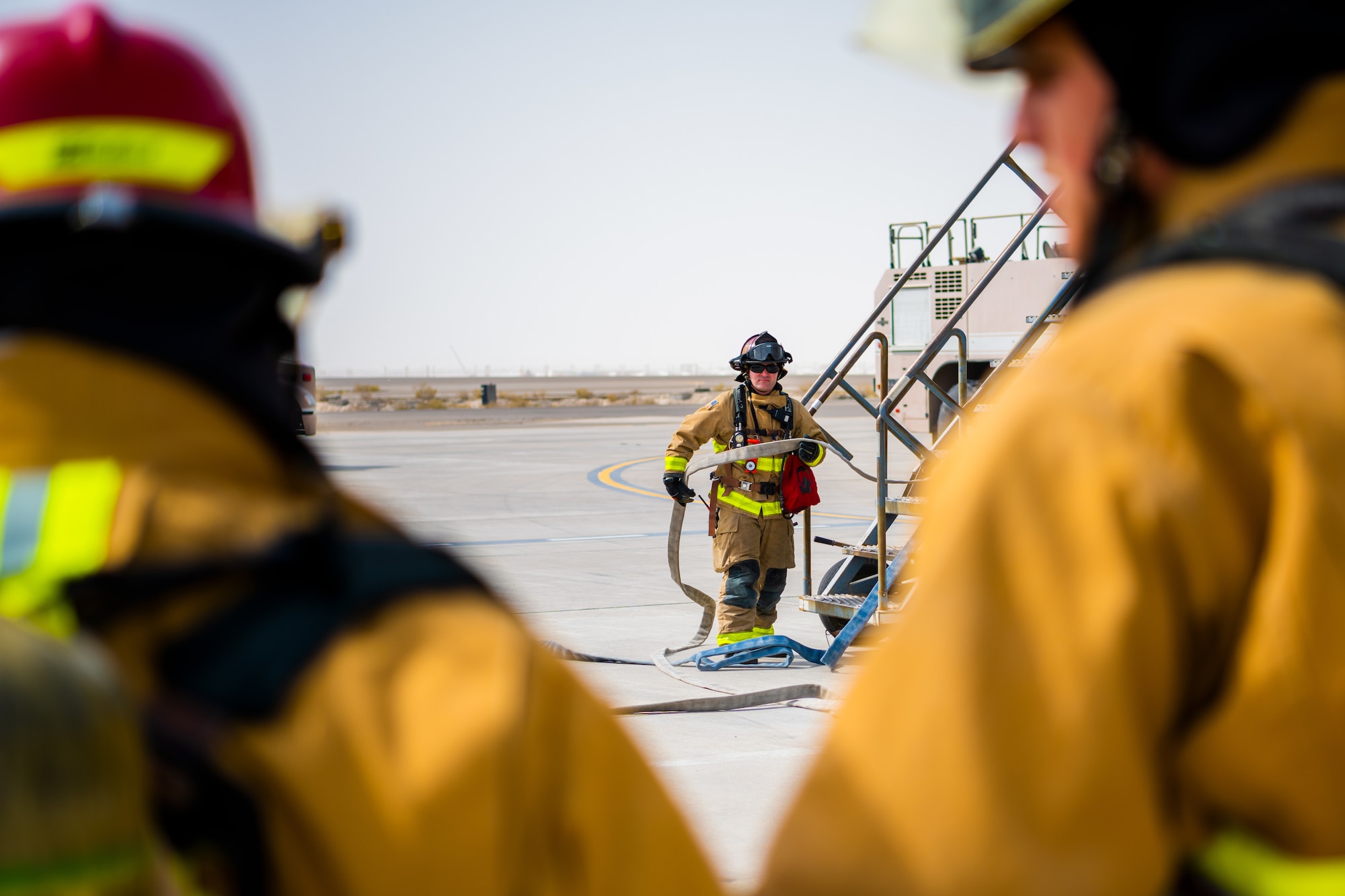 U.S. Air Force Airmen of the 380th Expeditionary Fire Department perform an exercise involving a KC-10 Extender aircraft at Al Dhafra Air Base, United Arab Emirates.